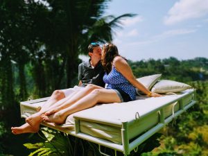 Justine and Scott kissing on the Bali Swing beds